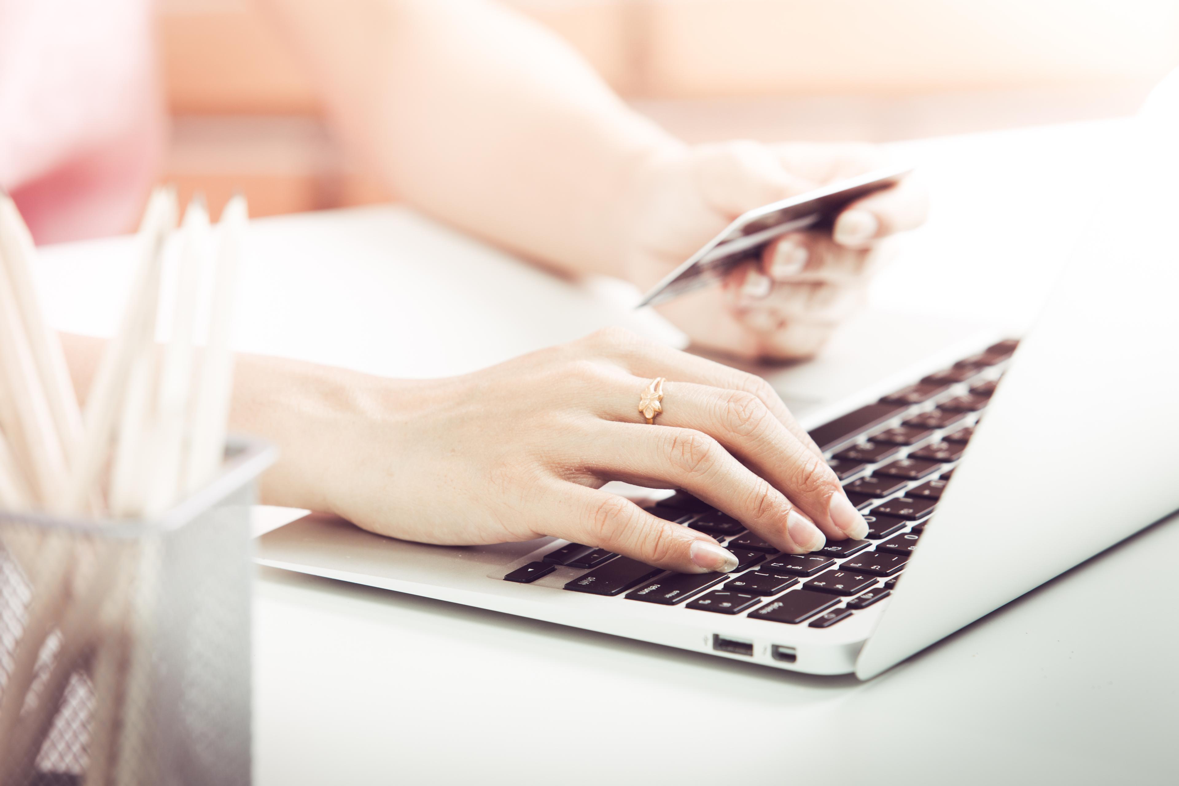 Person using credit card for laptop