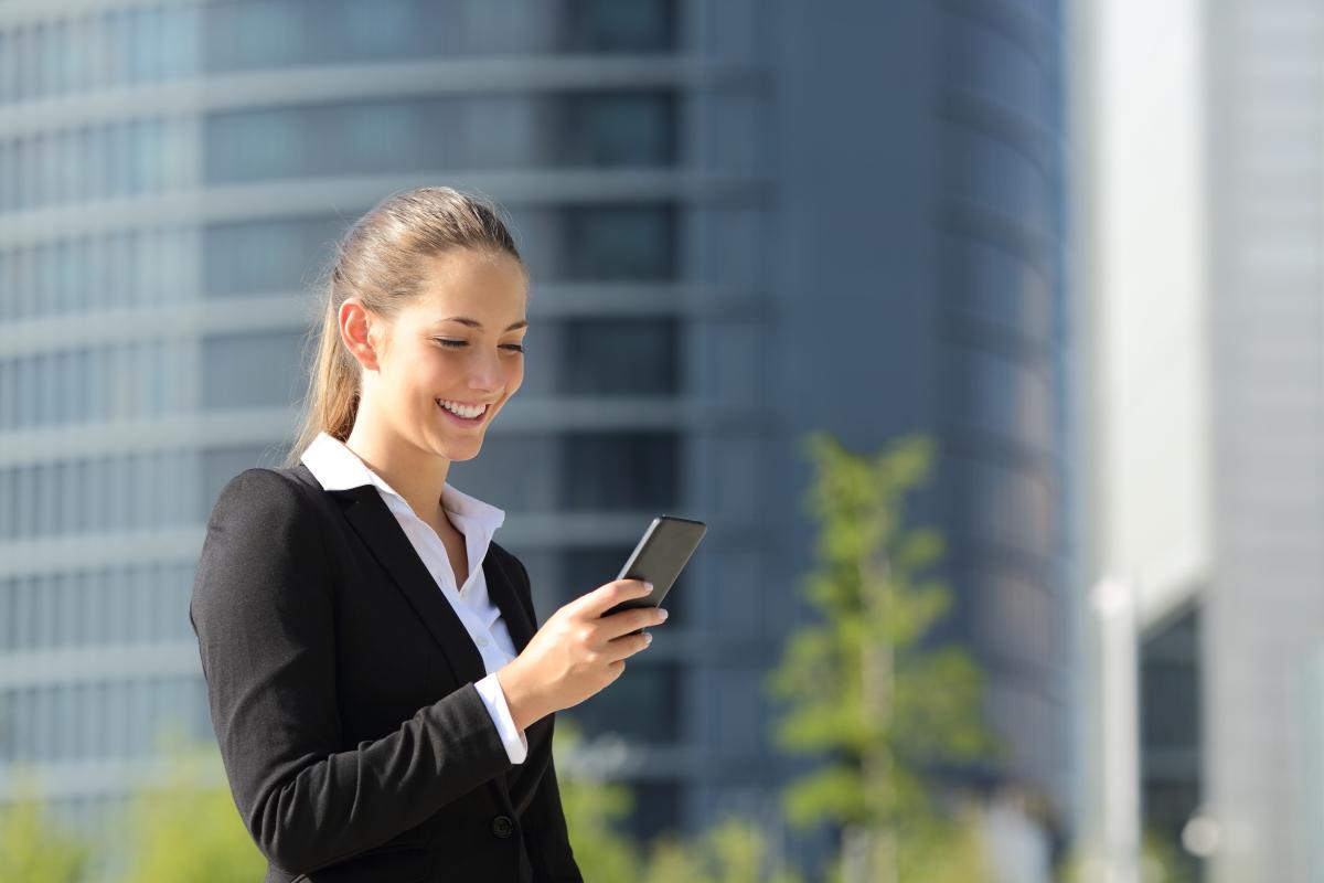 woman using a mobile and laughing