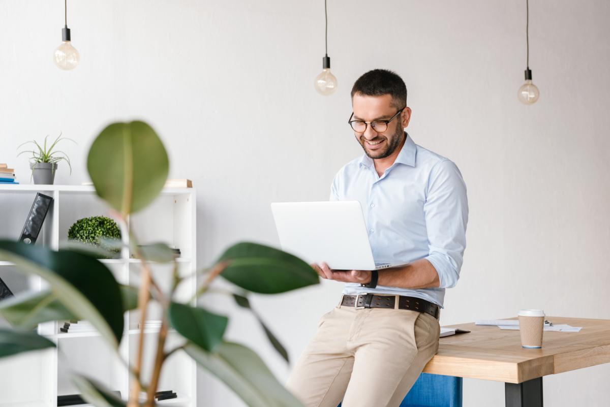 man standing using a computer